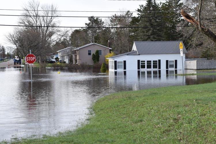 Flood waters overwhelmed the corner of Lesson Avenue and West Division Street in Cadillac Sunday morning, April 19, 2026. The area started to flood Saturday morning and by Saturday evening the city closed roads and worked to protect the sewer lift station.