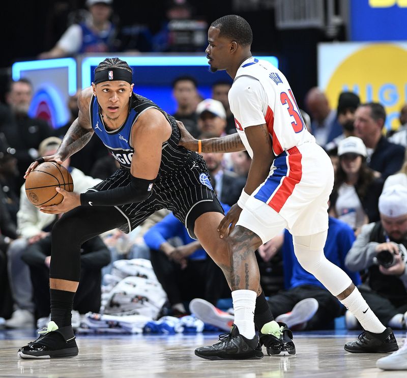 Orlando Magic forward Paolo Banchero (5) looks for room around Detroit Pistons guard Javonte Green (31) in the first half. Detroit Pistons vs Orlando Magic, Round 1/Game 1 at Little Caesars Arena on Sunday, April 19, 2026, in Detroit, Mich