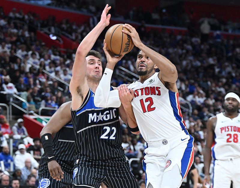 Detroit Pistons forward Tobias Harris (12) drives past Orlando Magic forward Franz Wagner (22) in the first half. Detroit Pistons vs Orlando Magic, Round 1/Game 1 at Little Caesars Arena on Sunday, April 19, 2026, in Detroit, Mich