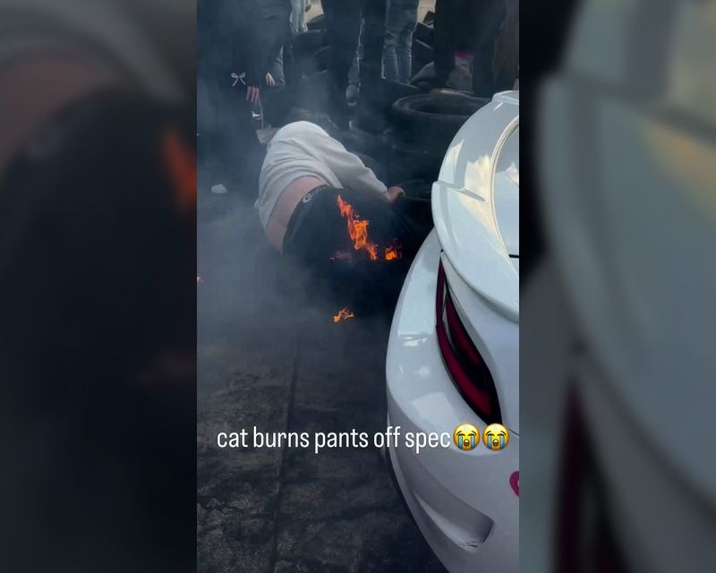 A spectator is seen on the ground with flames on his pants after a drifting vehicle backed into him at Jackson Speedway on Saturday, and the car's exhaust spit fire that set him ablaze. it's not believed he was seriously injured.