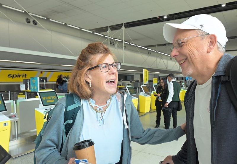 Spirit Airlines passengers Jeanne Koval and husband Alan Koval discuss the reasons they like Spirit Airlines, which faces the threat of liquidation, while waiting for a flight on the discount carrier to Orlando, Florida, at Detroit Metropolitan Wayne County Airport in Romulus on Monday, April 20, 2026.