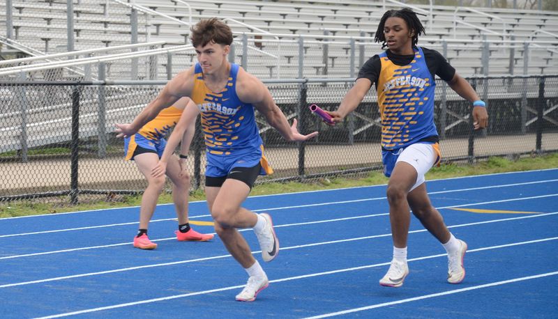 Zane Knezevich gets the baton from Jefferson teammate Zy'Rell Henley in the 800-meter relay during a 96-32 win over Flat Rock on Tuesday, April 21, 2026.