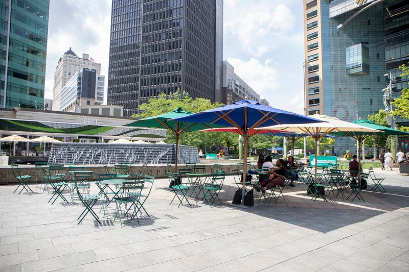 People cool off under the tent at Campus Martius Park on Wednesday, August 3, 2022. A heat advisory was announced until 8pm as temperatures are rising over 90 degrees.