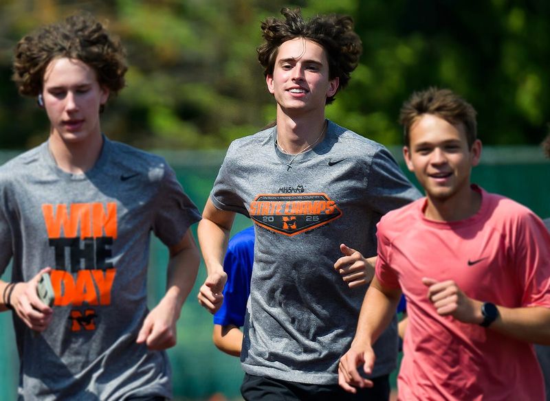 Northville’s Ryan Stojov, center, runs with teammates during track practice on Wednesday, April 22, 2026, at Northville High School.
