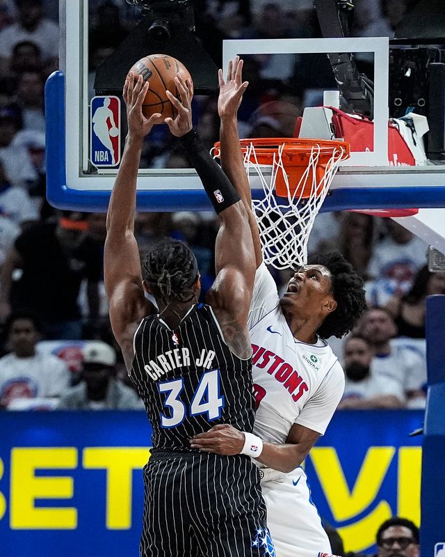 Detroit Pistons guard Ausar Thompson (9) blocks Orlando Magic center Wendell Carter Jr. (34) at the rim during the first half of Game 2 of the first round of the NBA playoffs at Little Caesars Arena in Detroit on Wednesday, April 22, 2026.