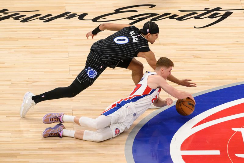 Detroit guard Kevin Huerter and Orlando guard Anthony Black battle for a loose ball during the first quarter of game two of an NBA semifinals game a game between the Detroit Pistons and the Orlando magic at Little Caesars Arena, in Detroit, April 22, 2026.