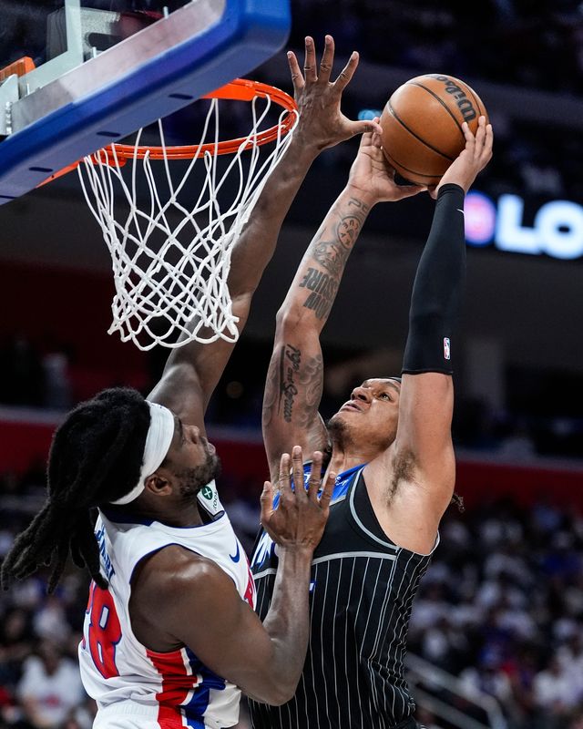 Detroit Pistons center Isaiah Stewart (28) blocks Orlando Magic forward Paolo Banchero (5) during the second half of Game 2 of the first round of the NBA playoffs at Little Caesars Arena in Detroit on Wednesday, April 22, 2026.