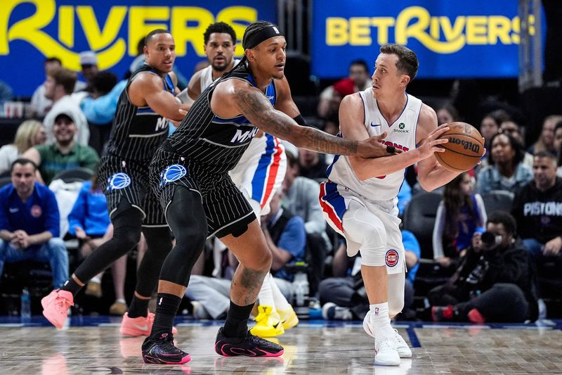 Detroit Pistons forward Duncan Robinson (55) looks to pass the ball against Orlando Magic forward Paolo Banchero (5) during the second half of Game 2 of the first round of the NBA playoffs at Little Caesars Arena in Detroit on Wednesday, April 22, 2026.