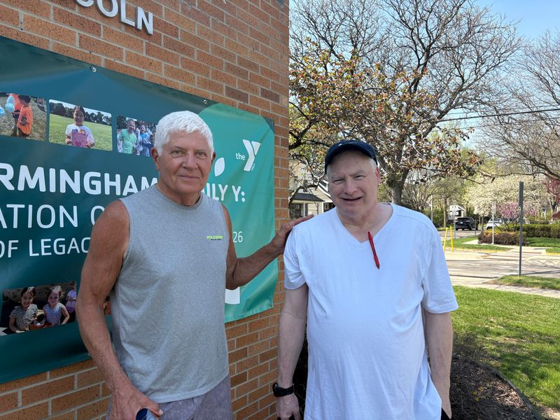John Dorr, left, and Bob Kuhn, who are both members of the YMCA, pose for a photo in front of the Birmingham Family YMCA on Thursday, April 23. The YMCA location is closing at the end of April.
