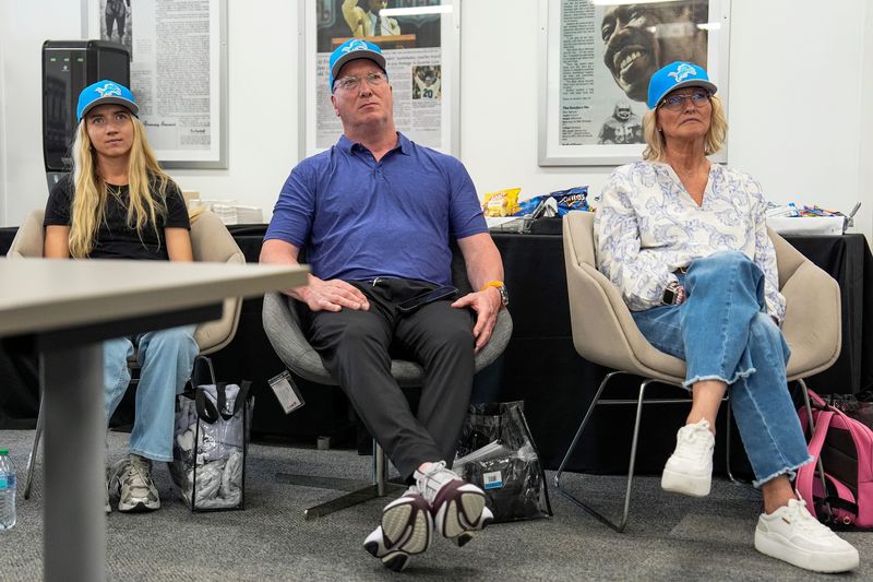From left, Detroit Lions first round draft Blake Miller’s girlfriend Kylie Jicha, father Chris Miller and mother Karen Miller watch Blake speaks during the introductory press conference at Meijer Performance Center in Allen Park on Friday, April 24, 2026.