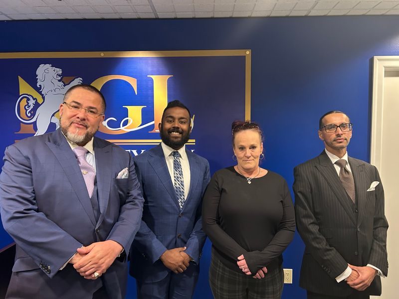 Theresa Tomasik of Waterford is suing FanDuel for not paying out her $154,160 in alleged winnings. She is photographed here with her lawyers at Not Guilty Law in Dearborn. (From left) Edward Martell, Muthu Veerappan and Mohammed Azeem Nasser.