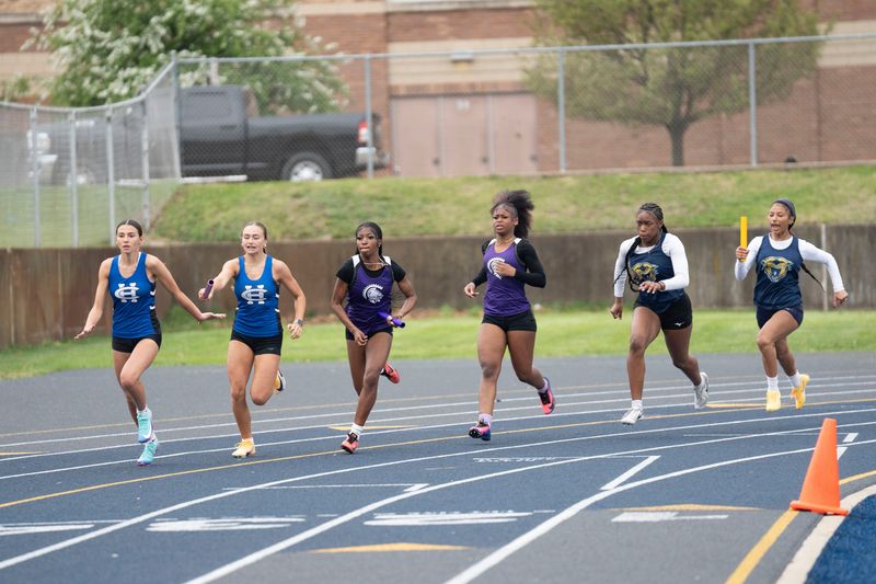 Runners compete in the 4x100 meter relay during the All-City meet at Battle Creek Central High School on Friday, April 24, 2026.