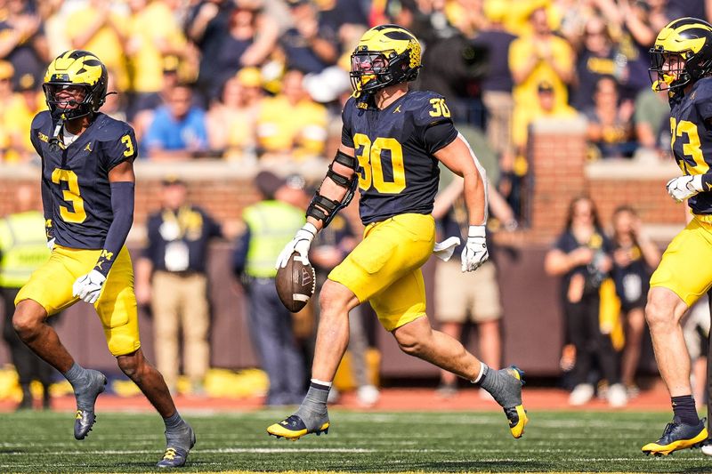 Michigan linebacker Jimmy Rolder (30) celebrates an interception against Washington during the second half at Michigan Stadium in Ann Arbor on Saturday, Oct. 18, 2025.