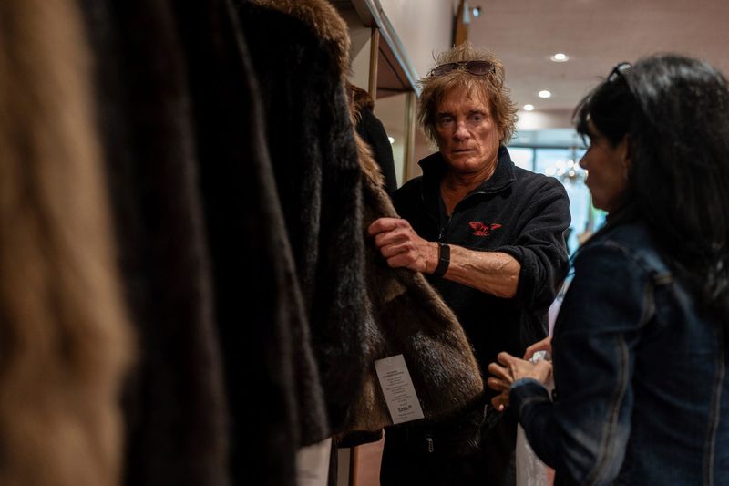 Danny “D” Dzialo, left, talks with Cynthia Diamond, a sales consultant, while looking through coats inside Dittrich Furs in Detroit on Saturday, April 25, 2026.
