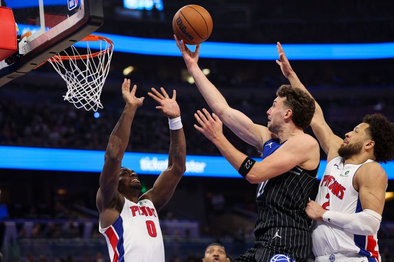 Magic forward Franz Wagner (22) drives to the basket guarded by Pistons center Jalen Duren (0) in the fourth quarter during Game 3 on Saturday.