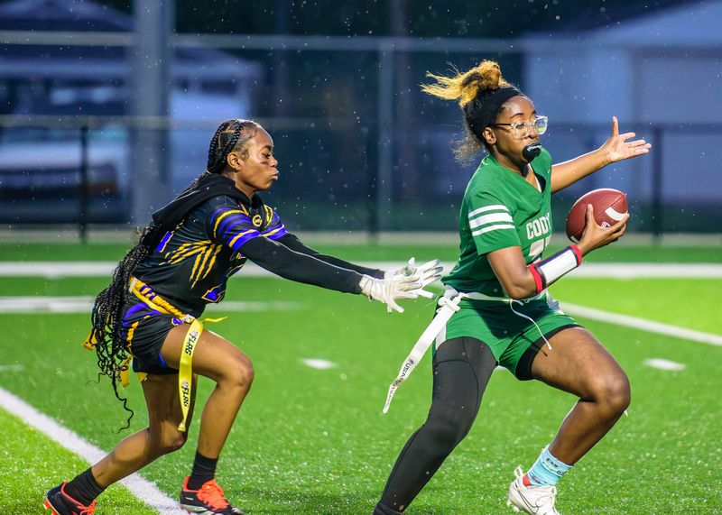 Redford Union's Dalilah Brents sacks Detroit Cody's Nevaeha Wheeler during a Michigan Girls High School Flag Football League game on Friday, April 24, 2026, at Bob Atkins Field.