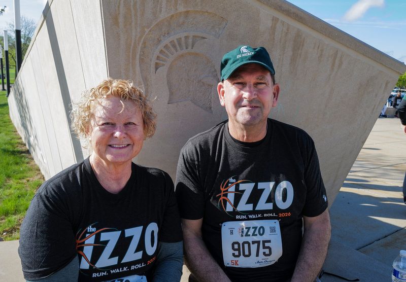 Tim and Kristen Gallagher from Lansing have been supporters of the Izzo Run/Walk/Roll and participants for the last two years and Kristen Gallagher said they "support it because of what they (Izzo family) do to help the community and it's such a little contribution." Photo: Sunday, April 26, 2026.