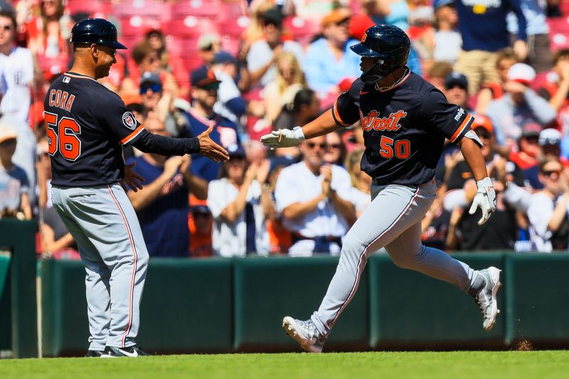 Detroit Tigers pinch hitter Hao-Yu Lee (50) reacts with third base coach Joey Cora (56) after hitting a two-run home run in the seventh inning against the Cincinnati Reds at Great American Ball Park in Cincinnati on Sunday, April 26, 2026.
