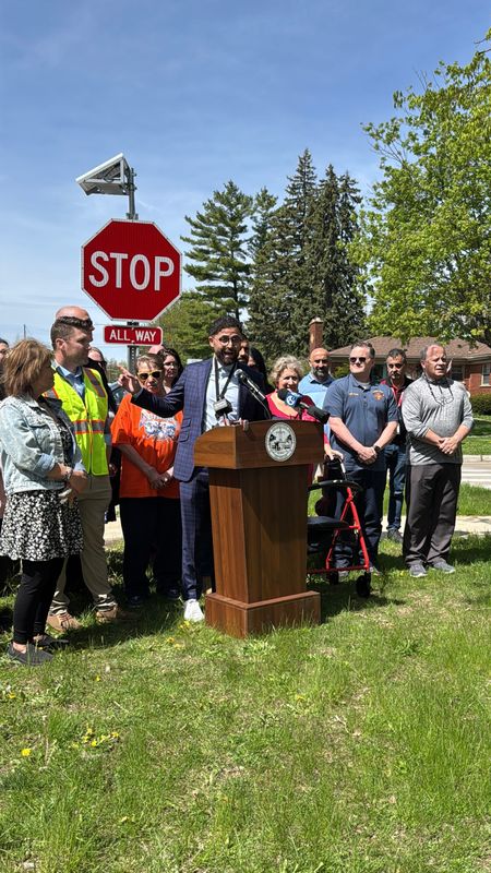 Dearborn Heights Mayor Mo Baydoun praises the city's initiative to install 250 flashing stop signs during a news conference on April 27, 2026. He spoke at the corner of Pardee Avenue and Annapolis Street, near where 12-year-old Joey Smith was hit and killed in 2022.