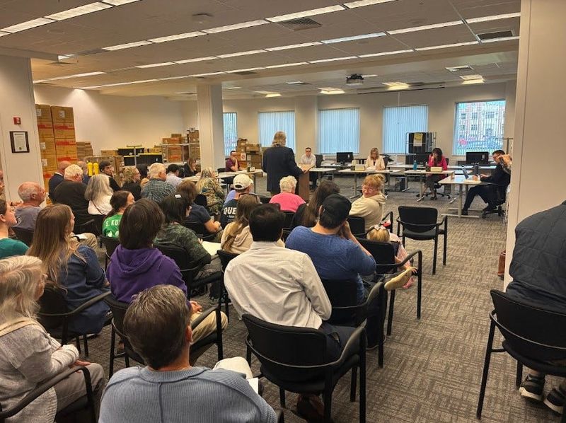 Residents pack out the Oakland County Board of Canvassers room on Monday, April 27, 2026, for a hearing for petition language to recall County Commissioner Dave Woodward.