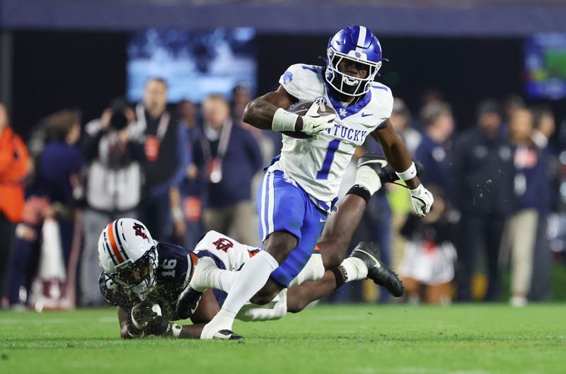 Nov 1, 2025; Auburn, Alabama, USA; Kentucky Wildcats wide receiver Kendrick Law (1) escapes the tackle of Auburn Tigers linebacker Bryce Deas (16) during the fourth quarter at Jordan-Hare Stadium. Mandatory Credit: John Reed-Imagn Images