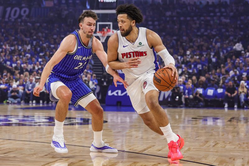 Pistons guard Cade Cunningham (2) drives around Magic forward Franz Wagner (22) during the first quarter during Game 4 of the first round of the 2026 NBA Playoffs at Kia Center.