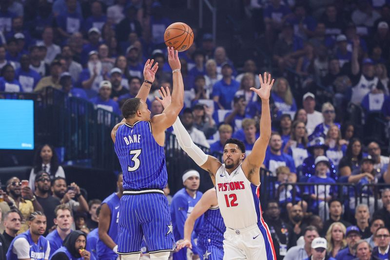 Orlando Magic guard Desmond Bane (3) shoots a three point basket against Detroit Pistons forward Tobias Harris (12) during Game 4 of the first round of the 2026 NBA playoffs at Kia Center in Orlando, Florida, on Monday, April 27, 2026.