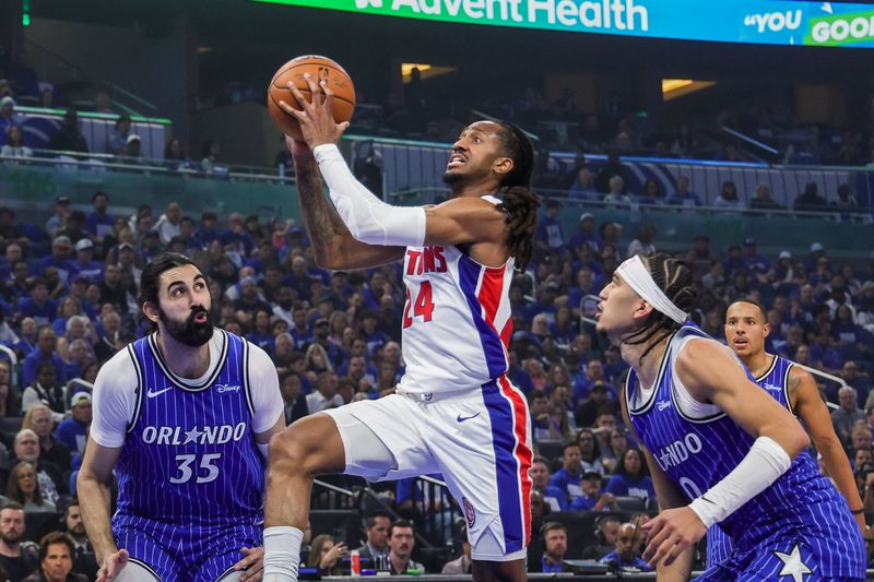 Apr 27, 2026; Orlando, Florida, USA; Detroit Pistons guard Daniss Jenkins (24) goes to the basket against Orlando Magic center Goga Bitadze (35) and guard Anthony Black (0) during the second quarter during game four of the first round of the 2026 NBA Playoffs at Kia Center. Mandatory Credit: Mike Watters-Imagn Images
