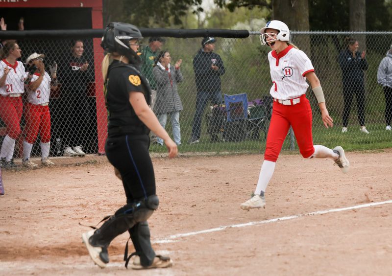 Madison Kuzara scores the winning run for New Boston Huron as Flat Rock catcher Quinn Robertson watches. Addison Ramsby drove in Kuzara to give the Chiefs a 4-3 victory on Monday, April 27, 2026.