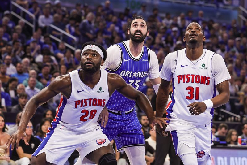Apr 27, 2026; Orlando, Florida, USA; Orlando Magic center Goga Bitadze (35), Detroit Pistons forward Isaiah Stewart (28) and guard Javonte Green (31) look for the rebound during the second half during game four of the first round of the 2026 NBA Playoffs at Kia Center. Mandatory Credit: Mike Watters-Imagn Images