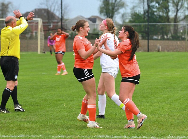 Michy Flores (right) and Briley Cripe celebrate after the first Sturgis goal against Paw Paw on Monday.
