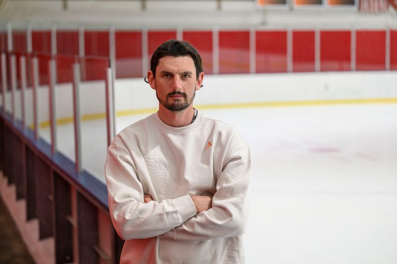 Commerce Township native Connor Hellebuyck stands in Lakeland Arena in Waterford Township, where he got his start playing hockey.