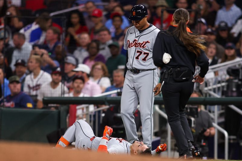 Detroit Tigers center fielder Javier Baez (28) goes down with an injury against the Atlanta Braves in the fifth inning at Truist Park in Atlanta on Tuesday, April 28, 2026.