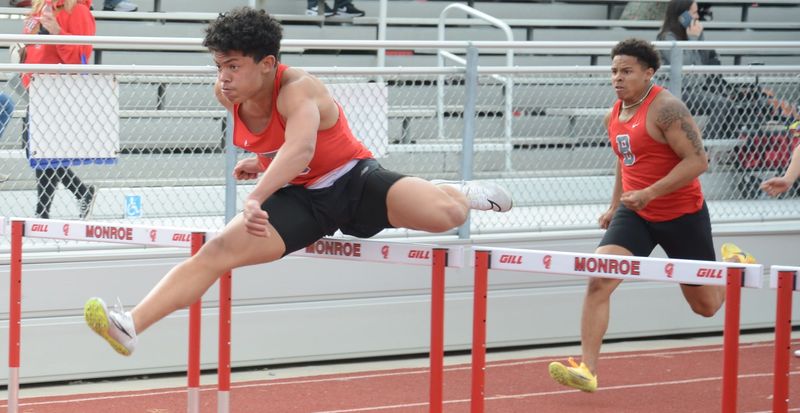 AJ Varner leads Bedford teammate Trenton Smithson in the high hurdles during an 85-52 victory over Monroe on Tuesday, April 28, 2026.