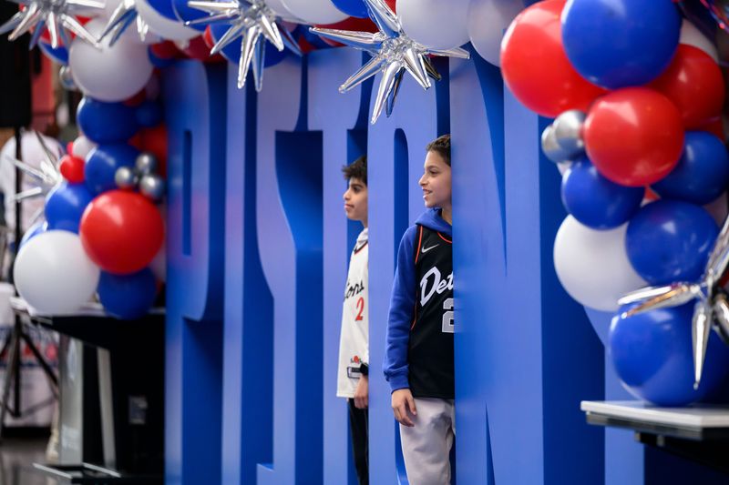 Noah Maizi, 11, and James Dallo, 10, of West Bloomfield pose for photos before the start of game five of the NBA quarterfinals between the Detroit Pistons and the Orlando Magic at Little Caesars Arena in Detroit on Wednesday. David Guralnick / The Detroit News