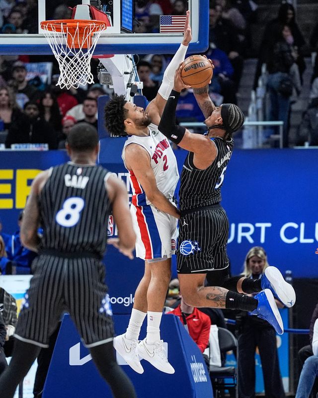 Detroit Pistons guard Cade Cunningham (2) blocks Orlando Magic forward Paolo Banchero (5) during the first half of Game 5 of First Round of NBA playoffs at Little Caesars Arena in Detroit on Wednesday, April 29, 2026.