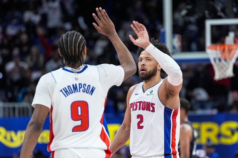 Detroit Pistons guard Cade Cunningham celebrates a play and high-fives forward Ausar Thompson against the Orlando Magic during the first half of Game 5 in the first round of the NBA playoffs at Little Caesars Arena in Detroit on Wednesday, April 29, 2026.