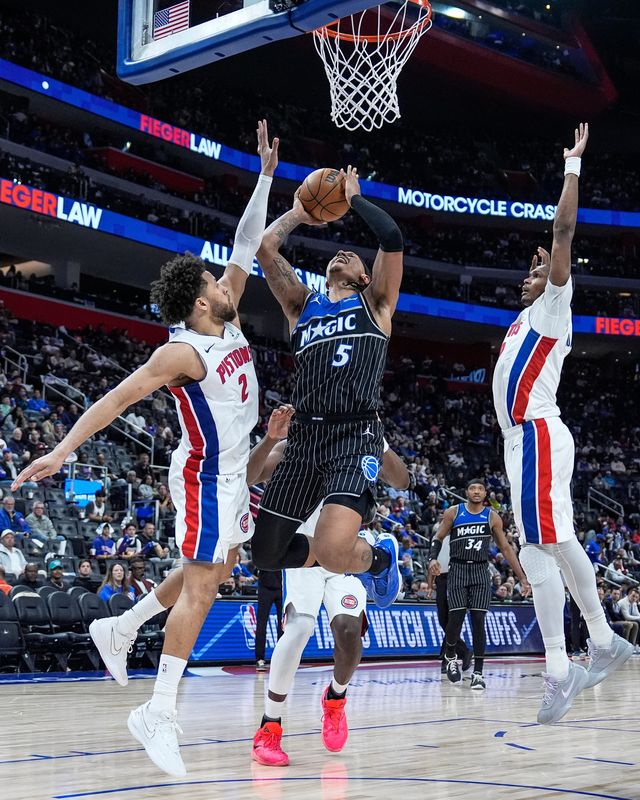 Detroit Pistons guard Cade Cunningham (2) defends Orlando Magic forward Paolo Banchero (5) during the second half of Game 5 of First Round of NBA playoffs at Little Caesars Arena in Detroit on Wednesday, April 29, 2026.