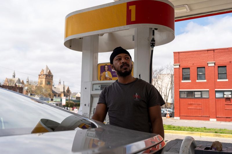 Darrell Schofield, of Detroit, pumps gas at a Shell station in Detroit on Tuesday, April 28, 2026.