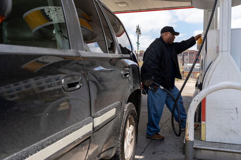 A man pumps gas at a Shell station in Detroit on Tuesday, April 28, 2026.