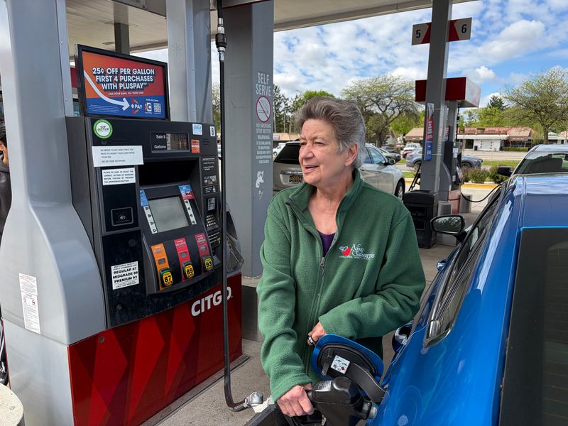 Geri Rickpart puts $30 of gas into her 2020 Ford Fuson Thursday at the Citgo station at Woodward Ave. and 12 Mile in Royal Oak.