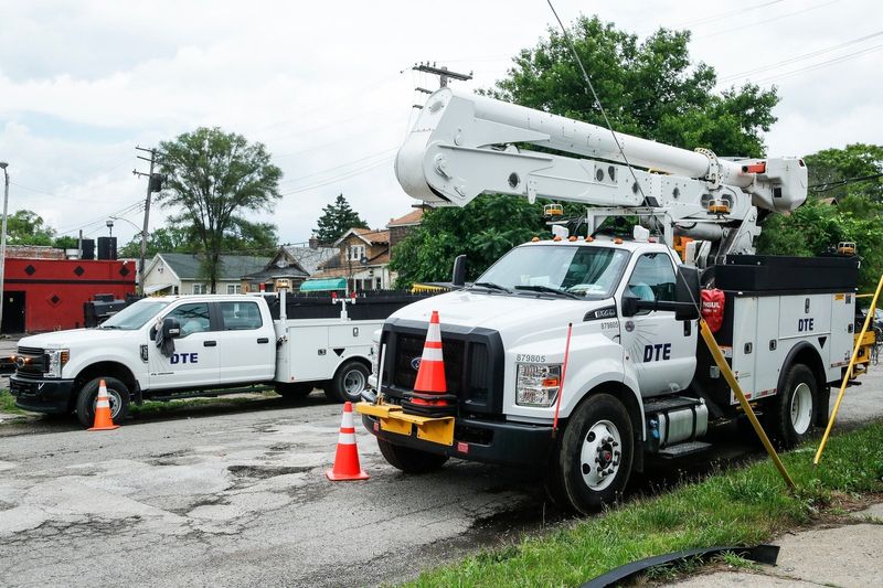A DTE crew on stand by near Midland Street and Livernois Avenue in Detroit waiting for repair location from the dispatch on June 30, 2021.