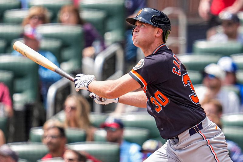 Apr 30, 2026; Cumberland, Georgia, USA; Detroit Tigers right fielder Kerry Carpenter (30) hits a triple against the Atlanta Braves during the eighth inning at Truist Park. Mandatory Credit: Dale Zanine-Imagn Images