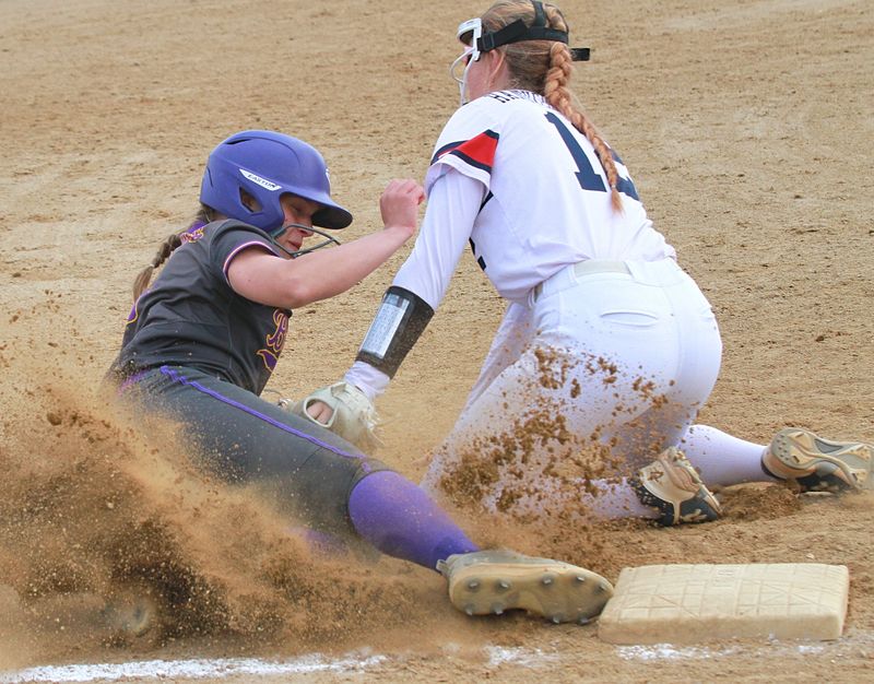 Delanee Carpenter slides safely into third base before a tag on Thursday.