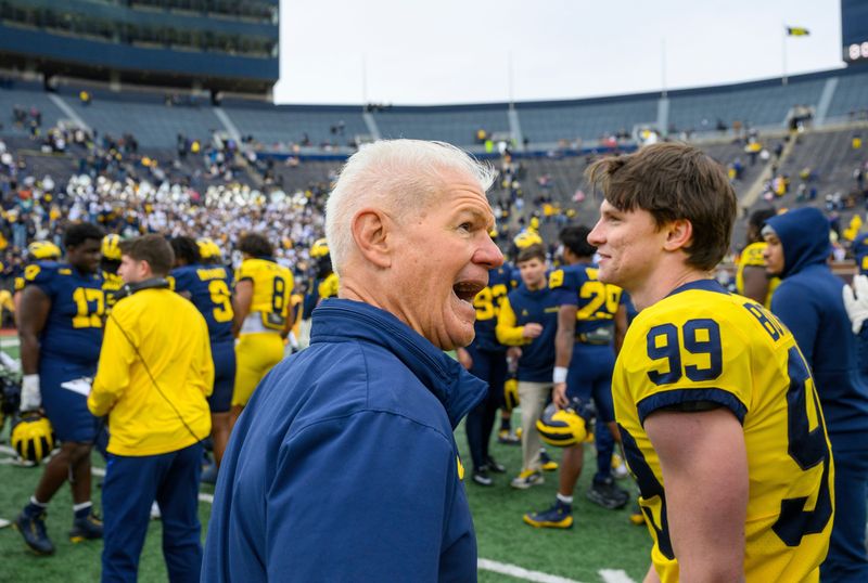 Michigan special teams coordinator Kerry Coombs and players gather on the field after the Maize vs. Blue spring game last month at Michigan Stadium.