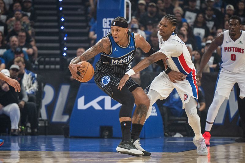 Magic forward Paolo Banchero (5) dribbles the ball against Pistons guard-forward Ausar Thompson (9) in the first quarter during Game 6 of the first round of the 2026 NBA Playoffs at Kia Center.
