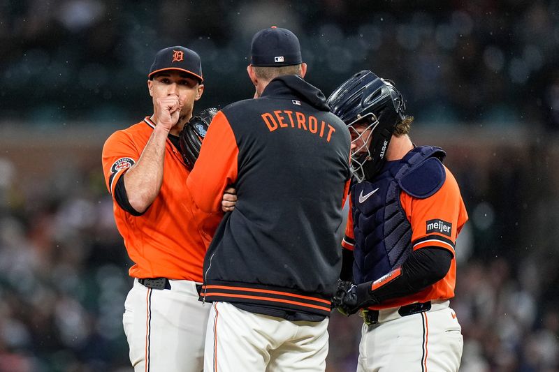 Detroit Tigers pitcher Jack Flaherty (9) gets a mound visit by pitching coach Chris Fetter (41) and catcher Dillon Dingler (13) during the third inning against Texas Rangers at Comerica Park in Detroit on Friday, May 1, 2026.