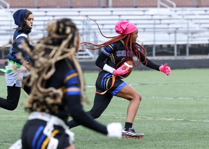 Redford Union's Kayleigh Goodman rushes during a Michigan Girls High School Flag Football League game on Friday, May 1, 2026, at Detroit Renaissance.