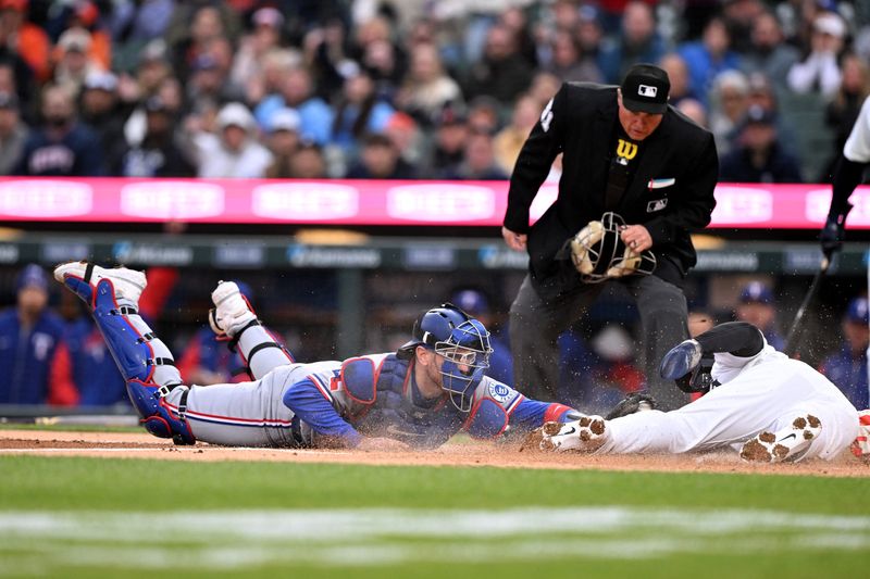 Texas Rangers catcher Danny Jansen (9) tags out Detroit Tigers second baseman Gleyber Torres (25) at home plate in the first inning.