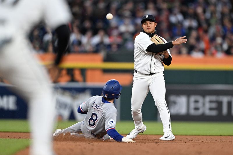 May 2, 2026; Detroit, Michigan, USA; Detroit Tigers second baseman Hao-Yu Lee (50) turns a double play over Texas Rangers second baseman Josh Smith (8) in the fifth inning at Comerica Park. Mandatory Credit: Lon Horwedel-Imagn Images